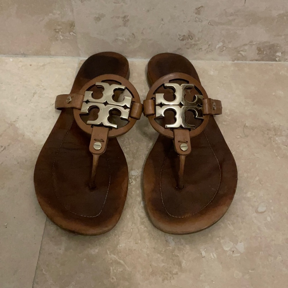 Tan Tory Burch sandals with gold symbol